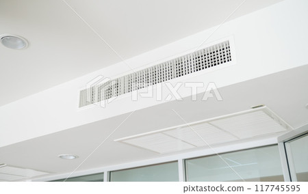 Ceiling mounted cassette type air conditioner and modern lamp light on white ceiling. duct air conditioner for home or office Ceiling mounted cassette type air conditioner and modern lamp light on white ceiling. duct air conditioner for home or office 117745595