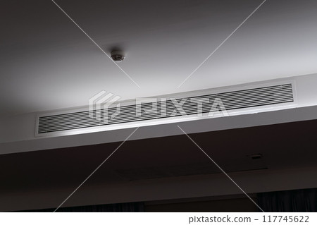 Ceiling mounted cassette type air conditioner and modern lamp light on white ceiling. duct air conditioner for home or office 117745622