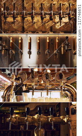 Multiple rows of beer taps, with different styles, finishes, and lighting, likely from various bars and breweries. Luxury bar atmosphere Multiple rows of beer taps, with different styles, finishes, and lighting, likely from various bars and breweries. Luxury bar atmosphere 117746651