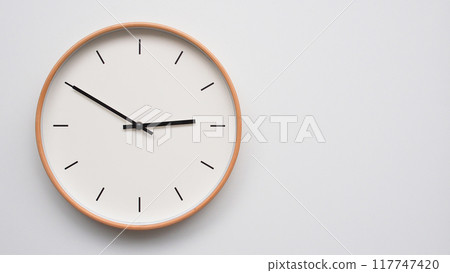 Minimalist wooden Wall Clock on White Wooden Surface with Space for Text. Time Set at 14.50, 02.50 117747420