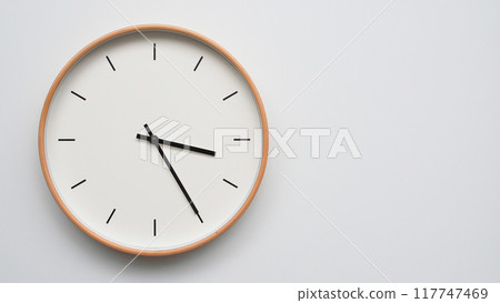 Minimalist wooden Wall Clock on White Wooden Surface with Space for Text. Time Set at 15.25/03.25 Minimalist wooden Wall Clock on White Wooden Surface with Space for Text. Time Set at 15.25/03.25 117747469