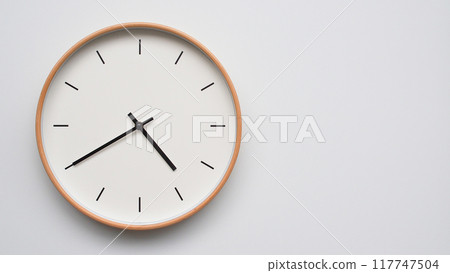 Minimalist wooden Wall Clock on White Wooden Surface with Space for Text. Time Set at 16.40/04.40 117747504