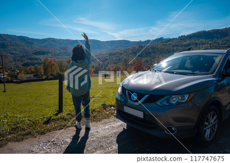 Woman Waving at Scenic Mountain View Woman Waving at Scenic Mountain View 117747675