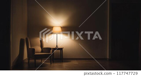A lamp and a chair in a slightly dimly lit room 117747729