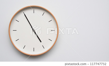 Minimalist wooden Wall Clock on White Wooden Surface with Space for Text. Time Set at 16.55/04.55 Minimalist wooden Wall Clock on White Wooden Surface with Space for Text. Time Set at 16.55/04.55 117747732