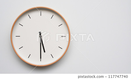 Minimalist wooden Wall Clock on White Wooden Surface with Space for Text. Time Set at 17.30/05.30 Minimalist wooden Wall Clock on White Wooden Surface with Space for Text. Time Set at 17.30/05.30 117747740