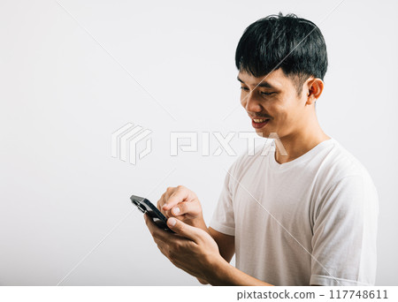 Portrait Asian smiling young man using mobile phone cellphone for social media studio isolated white background, Happy lifestyle men typing message on smartphone, mobile application online Portrait Asian smiling young man using mobile phone cellphone for social media studio isolated white background, Happy lifestyle men typing message on smartphone, mobile application online 117748611