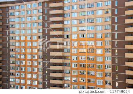 brown orange brick wall of multi-storey apartment building, full frame. architecture brick facade of panel high rise residential building 117749034