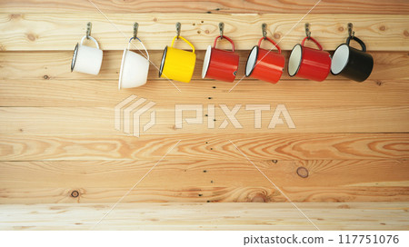 cups hanging on a wooden wall 117751076