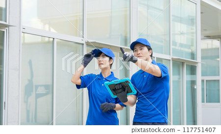 Workers inspecting the building 117751407