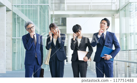 A group of business people who are worried in the office A group of business people who are worried in the office 117751488