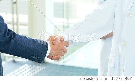 Businessman and doctor/researcher shaking hands Businessman and doctor/researcher shaking hands 117751497