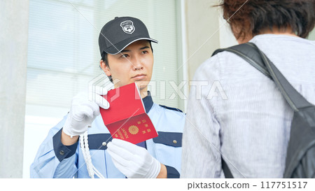 Security guard checking passports 117751517