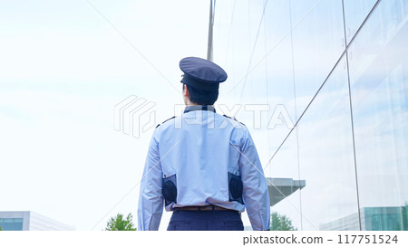 Security guard patrolling the building 117751524