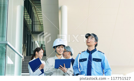 People of various professions inspecting a building (engineers, security guards, businessmen, researchers) 117751527