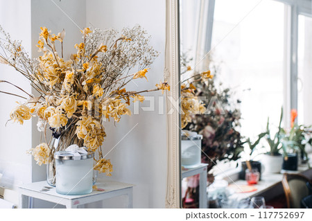 Dried flowers bouquet with a scented candle, rustic home decor, minimalist interior design, vintage aesthetic, calming atmosphere, home fragrance, dried floral arrangement 117752697