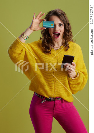 surprised trendy 40 years old woman against green background surprised trendy 40 years old woman against green background 117752784