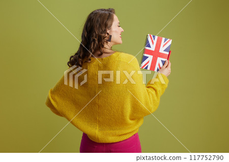 Seen from behind healthy woman against green background Seen from behind healthy woman against green background 117752790