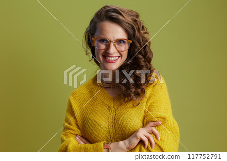 smiling fit woman in sweater and glasses isolated on green smiling fit woman in sweater and glasses isolated on green 117752791