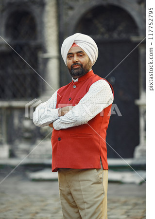 Indian man in a city. Male in a traditional turban. Hinduist in a summer city. 117752795