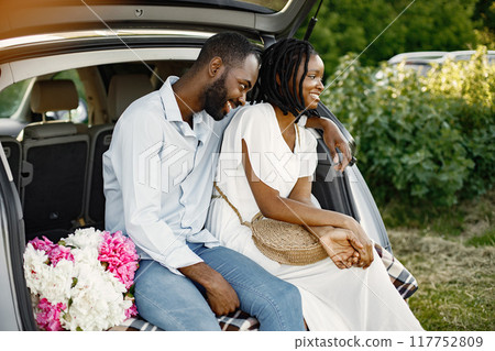 Smiling young couple sitting in back of car. African American ethnicity. Love, relationship concept. Smiling young couple sitting in back of car. African American ethnicity. Love, relationship concept. 117752809