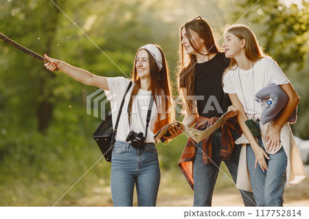 Adventure, travel, tourism, hike and people concept. Three girls in a forest. 117752814