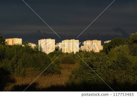 Residential, panel houses in the distance against the background of dark clouds Residential, panel houses in the distance against the background of dark clouds 117753483