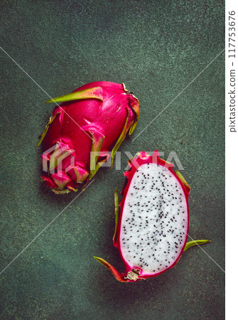 Dragon fruit, pitahaya, one piece, cut, top view, rustic style, green background, Dragon fruit, pitahaya, one piece, cut, top view, rustic style, green background, 117753676