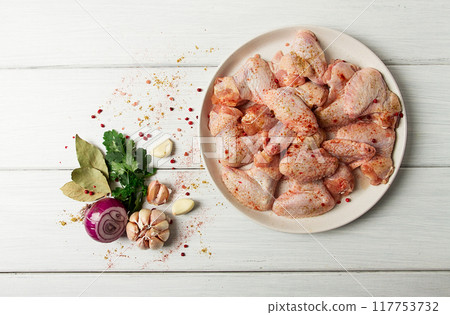 Fresh, raw chicken wings, with spices, on a white wooden table, 117753732