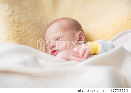 Little baby on white bed 117753774