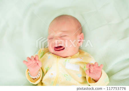 Little baby on white bed Little baby on white bed 117753776