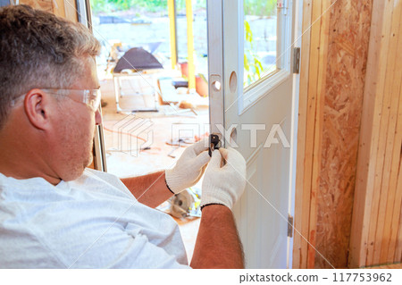 Lock doorknob installation by locksmith using screwdriver Lock doorknob installation by locksmith using screwdriver 117753962