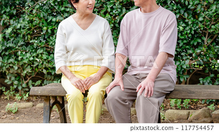 Senior couple sitting on a bench 117754457