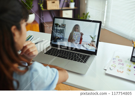 Attending Online Learning Session with Tutor on Laptop 117754805