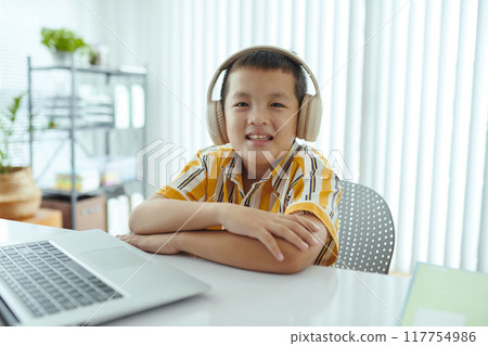 Portrait of Asian Child Listening to Music with Headphones 117754986