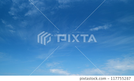 Soft white clouds moving on blue sky background. Tropical summer or spring sunlight. Daytime. Timelapse. Soft white clouds moving on blue sky background. Tropical summer or spring sunlight. Daytime. Timelapse. 117755287