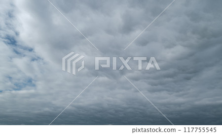 Cirrocumulus with ray light effects. Morning sunset blue sky with wispy smoke cirrocumulus. Timelapse. 117755545