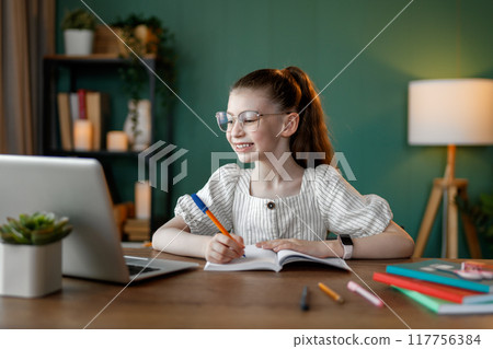 Girl doing homework Girl doing homework 117756384