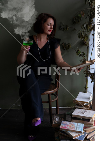 An Elegant Woman Holding a Refreshing Green Cocktail in a Tastefully Dimly Lit Setting That Captivates the Senses 117756445