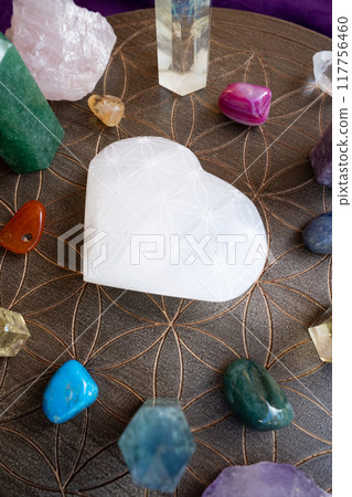 Healing crystals on brown background 117756460