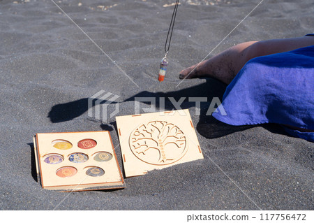 Healing crystals on black sand background Healing crystals on black sand background 117756472