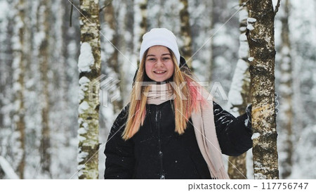 Portrait of a girl in winter in a birch forest. 117756747