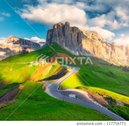 Aerial view of road in alpine mountains at sunset in summer Aerial view of road in alpine mountains at sunset in summer 117756771