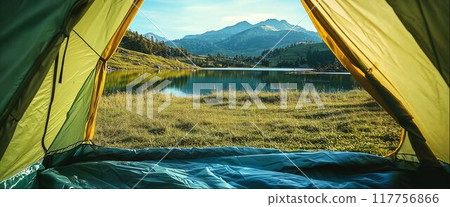 Tourist tent at campsite on shore of clear mountain lake, beautiful natural landscape with copy space, view from inside 117756866