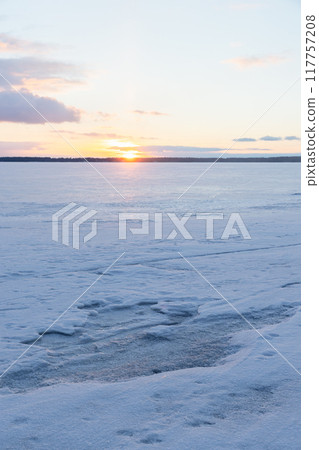 Winter landscape with frozen Baltic sea at sunset Winter landscape with frozen Baltic sea at sunset 117757208