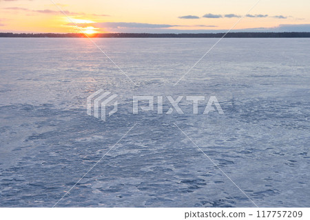 Winter landscape with frozen Baltic sea at sunset. Natural background 117757209