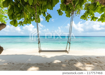 Scenic view of a pristine beach with crystal clear waters framed by lush green leaves and a wooden swing, offering a serene tropical escape Scenic view of a pristine beach with crystal clear waters framed by lush green leaves and a wooden swing, offering a serene tropical escape 117757468