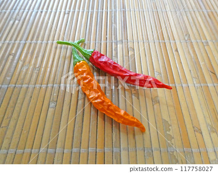 Photograph of red and yellow peppers grown in a home garden 117758027