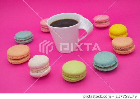 Vibrant Macarons with Black Coffee on Pink Background 117758179