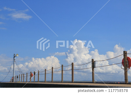 Blue sky with summer clouds floating in it Summer sky seen from the beach Summer image Blue sky with summer clouds floating in it Summer sky seen from the beach Summer image 117758578